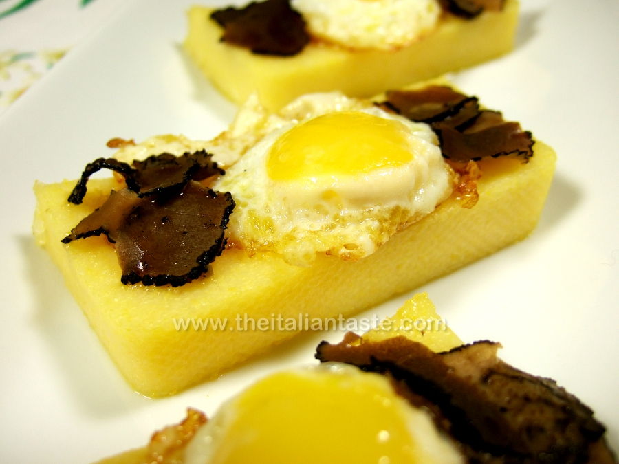 Quail eggs and black truffle on polenta slices