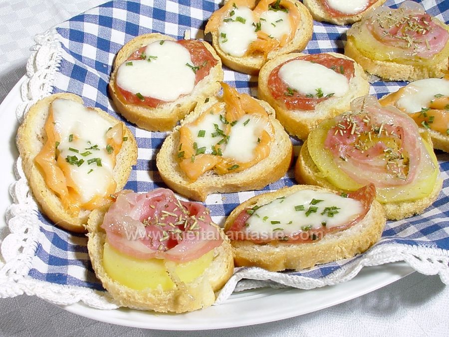 Crostini topped with salami, salmon and mozzarella